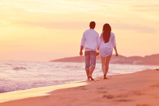 happy young romantic couple in love have fun on beautiful beach at beautiful summer day