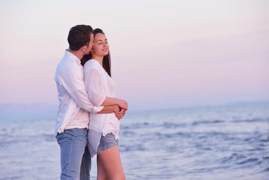 happy young romantic couple in love have fun on beautiful beach at beautiful summer day
