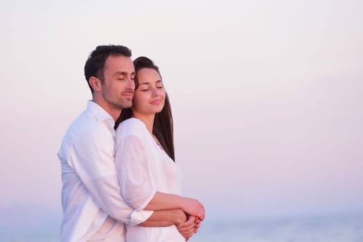 happy young romantic couple in love have fun on beautiful beach at beautiful summer day