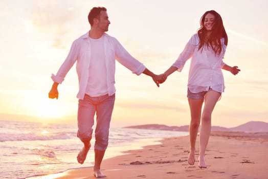 happy young romantic couple in love have fun on beautiful beach at beautiful summer day