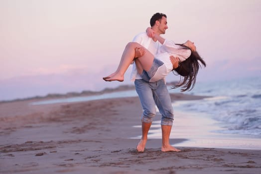 happy young romantic couple in love have fun on beautiful beach at beautiful summer day