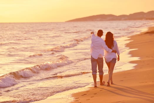 happy young romantic couple in love have fun on beautiful beach at beautiful summer day