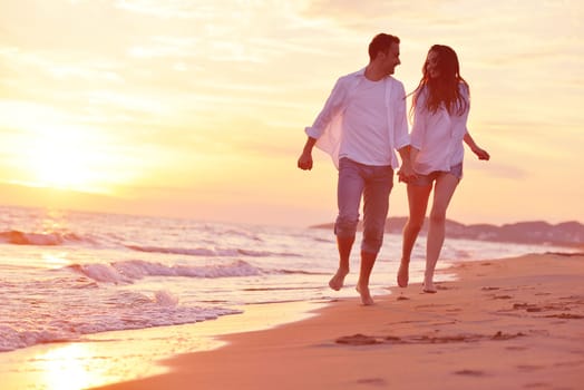 happy young romantic couple in love have fun on beautiful beach at beautiful summer day