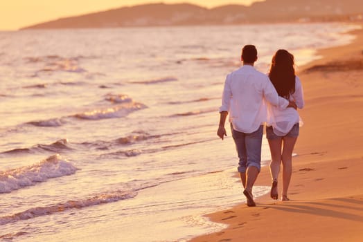 happy young romantic couple in love have fun on beautiful beach at beautiful summer day
