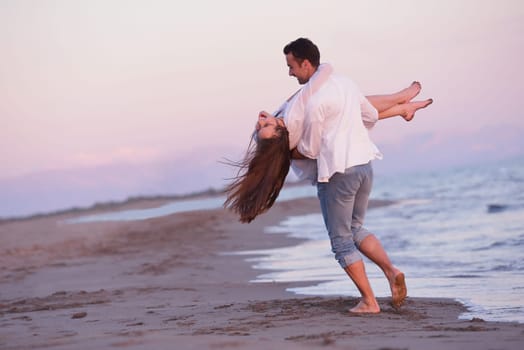 happy young romantic couple in love have fun on beautiful beach at beautiful summer day
