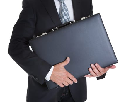 Close-up Of Businessman Holding Briefcase Over White Background
