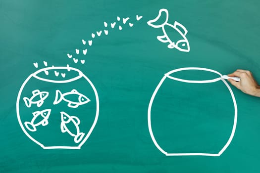 Fish escaping into empty tank on green blackboard