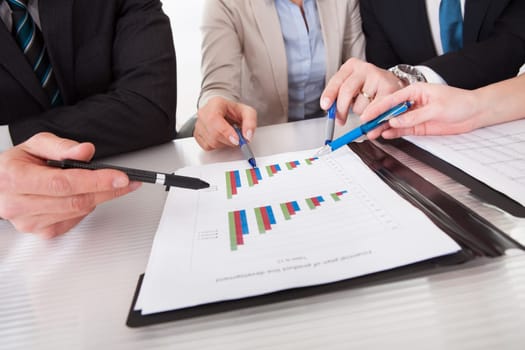 Close Up Of Business People Discussing New Project