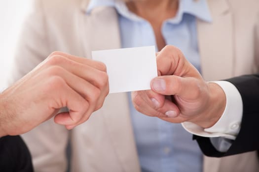 Two Businessman Exchanging Visiting Card In front Of Colleges