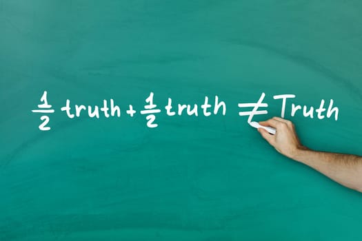 Half truth and half truth does not equal truth on green blackboard