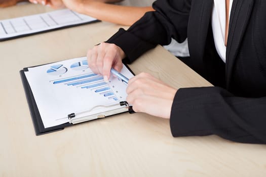 Image of female hands working with bar graphs