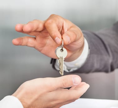 Close-up Of A Person Handover Keys To Man