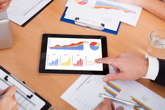 Close-up Of A Businesspeople Pointing Together On Digital Tablet