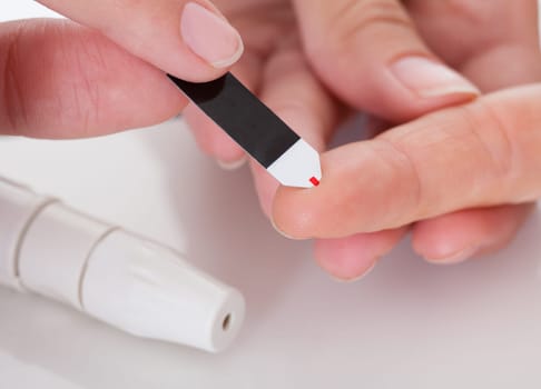 Close-up Of Hand Holding Device For Measuring Blood Sugar