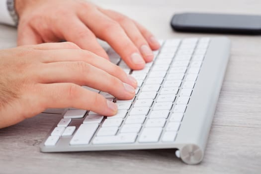 Close-up Of Male Hand Typing On Keyboard