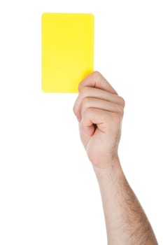 Closeup Of Male Soccer Referee Hand Holding Yellow Card