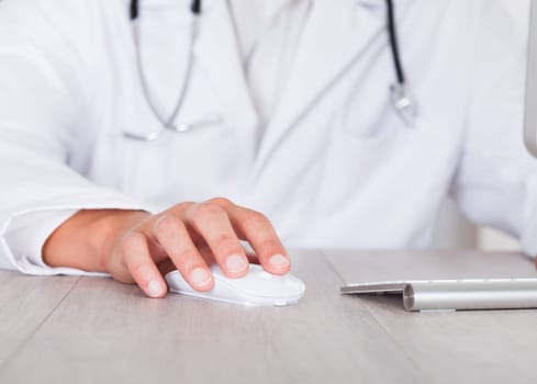 Close-up Of Male Doctor's Hand Using Computer