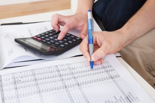 Portrait of young happy couple calculating budget