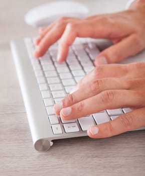 Closeup Of Businessman Using Computer At Desk