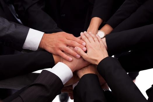 High angle view of a diverse group of people in a business team with their hands one on top of the other