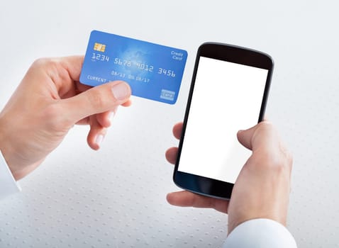 Man Holding Credit Card And Cell Phone Checking Account Balance