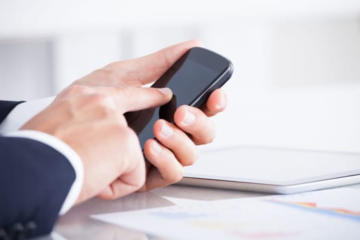 Close-up Of Businessman Using Cell Phone While Having A Break