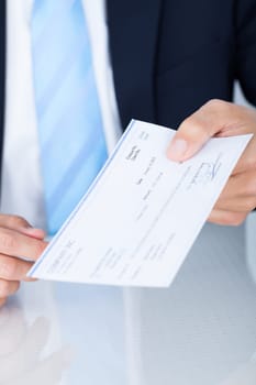 Portrait Of Young Happy Businessman Offering Cheque