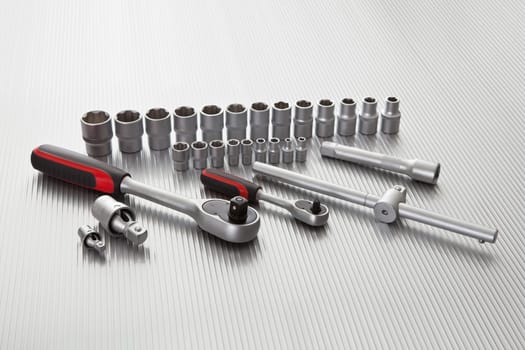 Metallic wrench tool set on metal background
