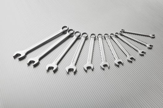 Metallic wrench tool set on metal background