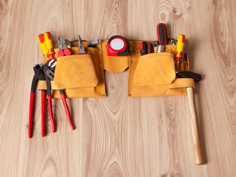 Toolbelt with various tools lying on the bench