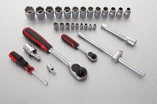 Metallic wrench tool set on metal background