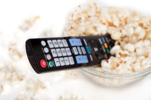 Close-up Of Remote Control In Bowl Of Popcorn Over White Background