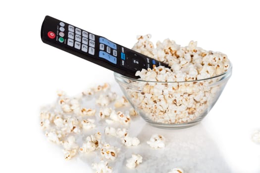 Close-up Of Remote Control In Bowl Of Popcorn Over White Background