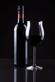 Bottle Of Wine And Glass Isolated On Black Background