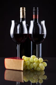 Still Life Of Wine Grapes And Cheese On Black Background