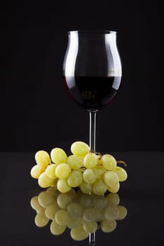 Still Life Of Wine And Grapes On Black Background