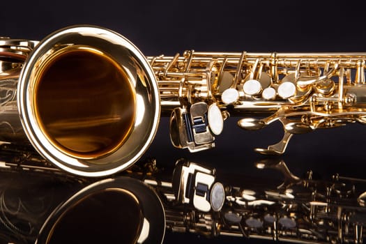 Close-up Of Trumpet Over Black Reflective Background
