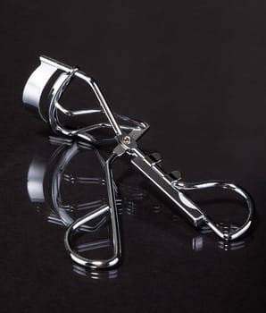 Close-up Of Eyelash Curler On Gray Background