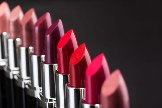 Lipsticks In A Row Isolated Over Gray Background