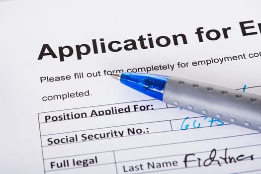 Closeup of filled application of employment and pen