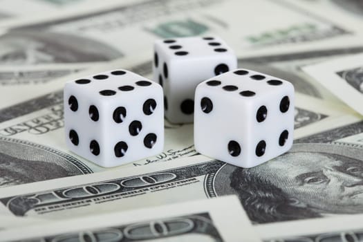 Photo of playing dices and american dollars