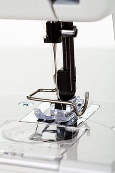 Close-up of sewing machine. Isolated on white