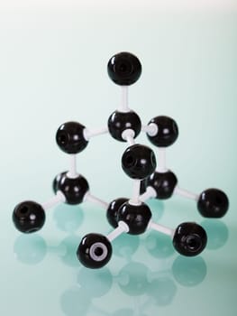 Model of graphite  molecular structure on green reflective background