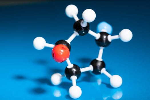 Model of molecular structure on blue reflective background