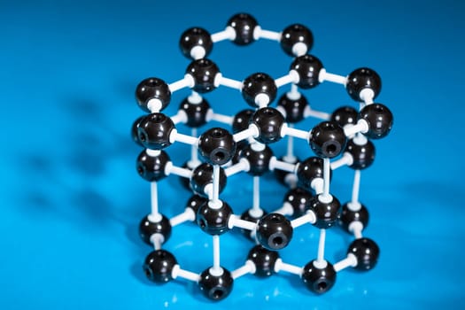 Model of graphite molecular structure on green reflective background