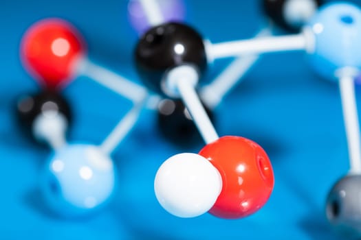 Model of molecular structure on blue reflective background