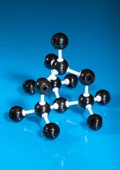 Model of graphite  molecular structure on blue reflective background