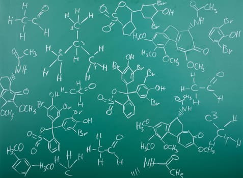 Organic chemical formulas on a green chalkboard
