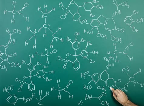 Organic chemical formulas on a green chalkboard