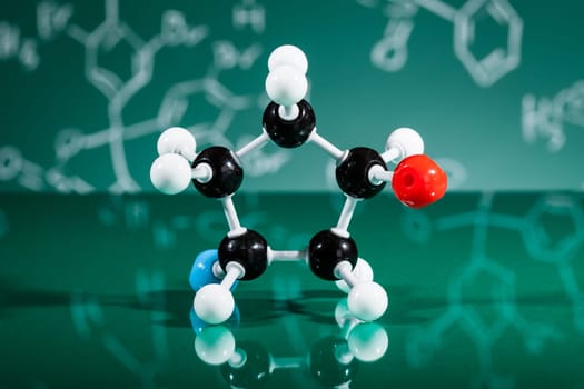 Model of molecular structure on green reflective background
